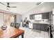 Bright kitchen featuring tile floors, gray cabinetry and a stainless steel dishwasher at 3121 River Birch Dr, Indianapolis, IN 46235