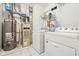 The laundry room has a washer, dryer, water heater, and shelving for storage at 3121 River Birch Dr, Indianapolis, IN 46235
