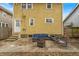 Backyard patio with outdoor seating, fire pit, and access to home entrance at 3416 Guilford Ave, Indianapolis, IN 46205