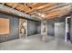 Unfinished basement with exposed ceiling, gray painted walls, and storage possibilities at 3416 Guilford Ave, Indianapolis, IN 46205
