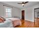 Bedroom with hardwood floors, ceiling fan and a large window at 3416 Guilford Ave, Indianapolis, IN 46205