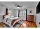 Bright bedroom with hardwood floors, white walls, two windows, and a ceiling fan at 3416 Guilford Ave, Indianapolis, IN 46205