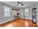 Bedroom with hardwood floors, ceiling fan, desk and shelving at 3416 Guilford Ave, Indianapolis, IN 46205