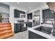 Well-appointed kitchen with black cabinetry, white marble countertops, and modern stainless steel appliances at 3416 Guilford Ave, Indianapolis, IN 46205
