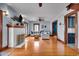 Bright living room featuring hardwood floors, a white fireplace, a ceiling fan, and multiple windows at 3416 Guilford Ave, Indianapolis, IN 46205