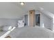 Bright attic space features neutral walls and carpet, with a decorative brick chimney element at 4034 W 700 S, Shelbyville, IN 46176