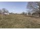 The spacious backyard includes some mature trees and an outbuilding, offering a private outdoor space at 4034 W 700 S, Shelbyville, IN 46176