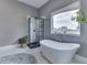 This luxurious bathroom features a soaking tub and black-framed shower at 4034 W 700 S, Shelbyville, IN 46176