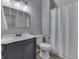 Bathroom with a decorative mirror, a vanity with drawers and a cabinet, and a shower with curtain at 4034 W 700 S, Shelbyville, IN 46176