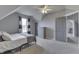 Inviting bedroom features neutral walls and carpet, a window, and a gray dresser for storage at 4034 W 700 S, Shelbyville, IN 46176