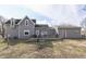 Rear exterior view of home with gray siding, a black roof, and a deck surrounded by a yard at 4034 W 700 S, Shelbyville, IN 46176