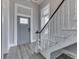 A foyer with a beautiful door, stylish stairs, and modern gray floors at 4034 W 700 S, Shelbyville, IN 46176