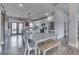 Bright, open kitchen with stainless steel appliances, island seating, and adjacent dining area at 4034 W 700 S, Shelbyville, IN 46176