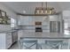 Bright kitchen featuring stainless steel appliances, an island with seating, and ample white cabinetry at 4034 W 700 S, Shelbyville, IN 46176