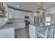 Modern kitchen with white cabinets, stainless steel appliances, subway tile backsplash, and island seating at 4034 W 700 S, Shelbyville, IN 46176
