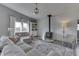 Bright living room with a traditional wood burning stove, comfortable seating, and neutral tones at 4034 W 700 S, Shelbyville, IN 46176