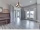 Bright living room with wood-look floors, modern chandelier and fireplace, and neutral paint at 4034 W 700 S, Shelbyville, IN 46176