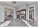 Bright living room with wood-look floors, fireplace with decorative mirror, and neutral paint at 4034 W 700 S, Shelbyville, IN 46176