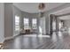 Bright living room with wood-look floors, modern lighting, and neutral paint at 4034 W 700 S, Shelbyville, IN 46176