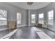 Open-concept living room featuring wood-look floors and lots of natural lighting at 4034 W 700 S, Shelbyville, IN 46176