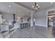 Bright and airy living room with wood-look floors, wood-burning stove, modern lighting, and neutral paint at 4034 W 700 S, Shelbyville, IN 46176