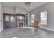 Living room with wood-look floors, fireplace with decorative mirror, and neutral paint at 4034 W 700 S, Shelbyville, IN 46176