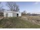 Outbuilding with metal siding and roofing on a grassy lot, offering ample space for storage or hobbies at 4034 W 700 S, Shelbyville, IN 46176