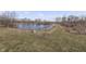 Picturesque pond surrounded by trees and grassy areas, enhancing the property's natural beauty at 4034 W 700 S, Shelbyville, IN 46176