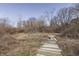 Rustic wooden planks traverse the wild grasses and natural beauty of the grounds at 4034 W 700 S, Shelbyville, IN 46176