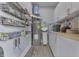 Utility room features a water heater, water softener, shelving, and modern cabinets for storage at 4034 W 700 S, Shelbyville, IN 46176