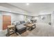 Finished basement featuring a gray couch, coffee tables, and game table for Gathering fun at 4905 Andover Pkwy, Westfield, IN 46062