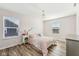 Bright bedroom features wood floors, a window, and a chandelier for a warm, inviting space at 4905 Andover Pkwy, Westfield, IN 46062
