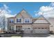 Charming two-story home with a mix of brick and siding exterior, and a well-manicured front yard at 4905 Andover Pkwy, Westfield, IN 46062
