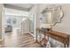 Tastefully decorated foyer featuring hard wood floors, modern mirrors and staircase access, with a view to the living room at 4905 Andover Pkwy, Westfield, IN 46062
