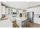 Bright and modern kitchen featuring white cabinets, stainless steel appliances, and a central island with bar seating at 4905 Andover Pkwy, Westfield, IN 46062