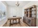 Stylish home office featuring wood floors, a decorative accent wall, and a classic wooden desk and shelving unit at 4905 Andover Pkwy, Westfield, IN 46062