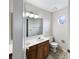 Bathroom featuring double sinks, wooden cabinets, and an octagon-shaped window at 5107 Stirling Point Dr, Indianapolis, IN 46241