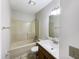 This bathroom features a tub and shower combo, vanity sink with wood cabinets and neutral walls at 5107 Stirling Point Dr, Indianapolis, IN 46241