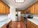Functional kitchen with wood cabinets, stainless steel appliances, and durable countertops at 5107 Stirling Point Dr, Indianapolis, IN 46241