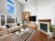 Bright and airy living room with a fireplace, large windows, and stylish furnishings at 5107 Stirling Point Dr, Indianapolis, IN 46241