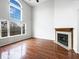 Bright living room showcasing a fireplace and large windows with an outdoor view at 5107 Stirling Point Dr, Indianapolis, IN 46241