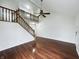 Bright living room featuring wood floors, a staircase, and a ceiling fan at 5107 Stirling Point Dr, Indianapolis, IN 46241