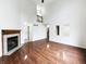 Open living room featuring wood floors, a fireplace, and staircase access at 5107 Stirling Point Dr, Indianapolis, IN 46241