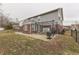 Fenced backyard with a concrete patio, grill, and mature trees provides a private retreat at 5328 Kidwell Cir, Indianapolis, IN 46239