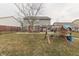 Expansive backyard features a concrete patio, mature trees, and a swing set for outdoor enjoyment at 5328 Kidwell Cir, Indianapolis, IN 46239