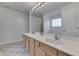 Bright Primary bathroom with double sinks, framed mirror, and tile flooring at 5328 Kidwell Cir, Indianapolis, IN 46239