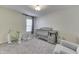 Neutral Bedroom featuring a gray crib with changing table and a comfortable glider chair at 5328 Kidwell Cir, Indianapolis, IN 46239