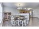 Bright dining area open to the kitchen with dark laminate flooring and natural light at 5328 Kidwell Cir, Indianapolis, IN 46239