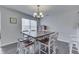 Dining area with a large wooden table and seating open to a bright living space at 5328 Kidwell Cir, Indianapolis, IN 46239