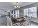 Open dining room with a modern chandelier, dark floors, and natural light at 5328 Kidwell Cir, Indianapolis, IN 46239